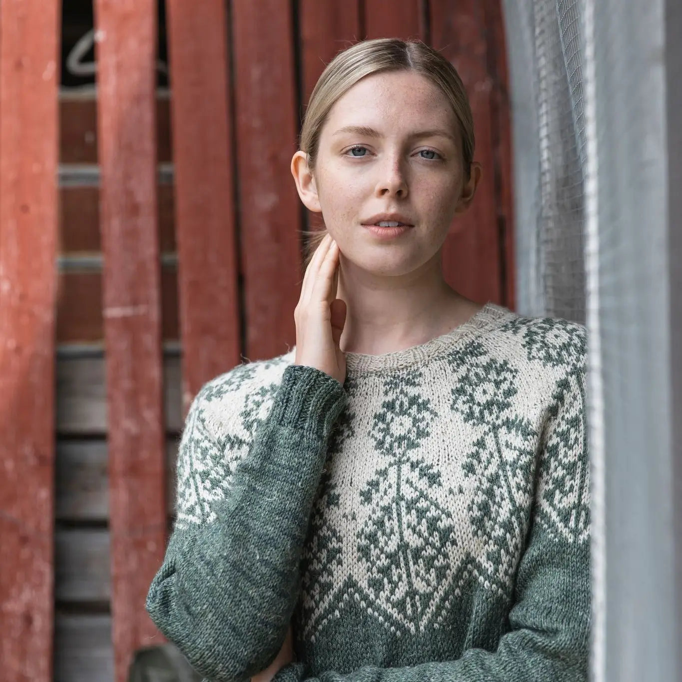 a woman wearing a green and white sweater