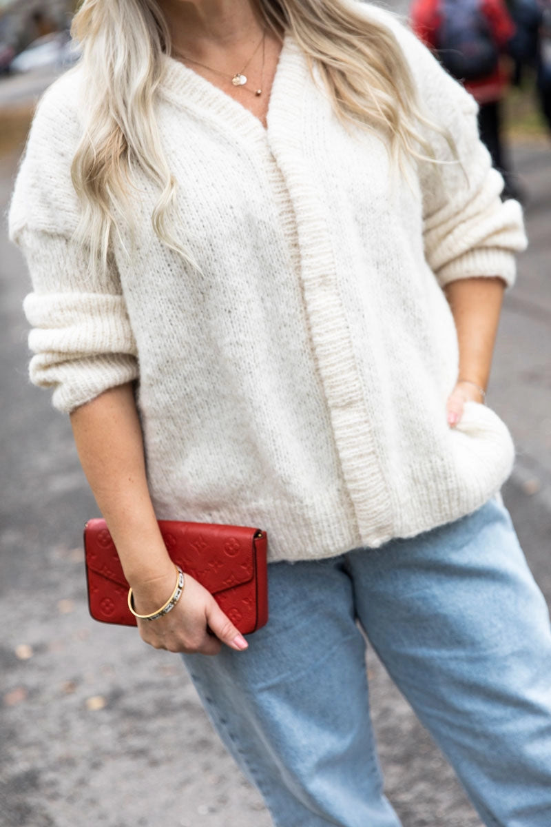 a creamy white sweater worn with jeans