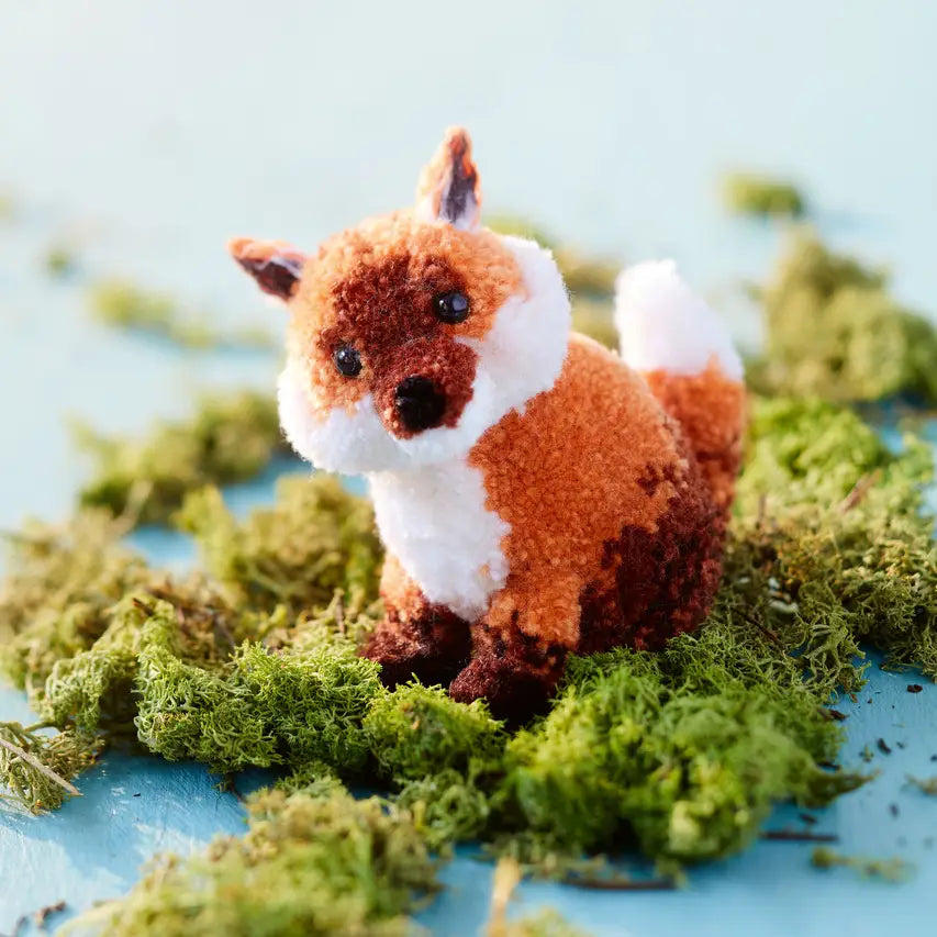 a red and white pom pom reindeer