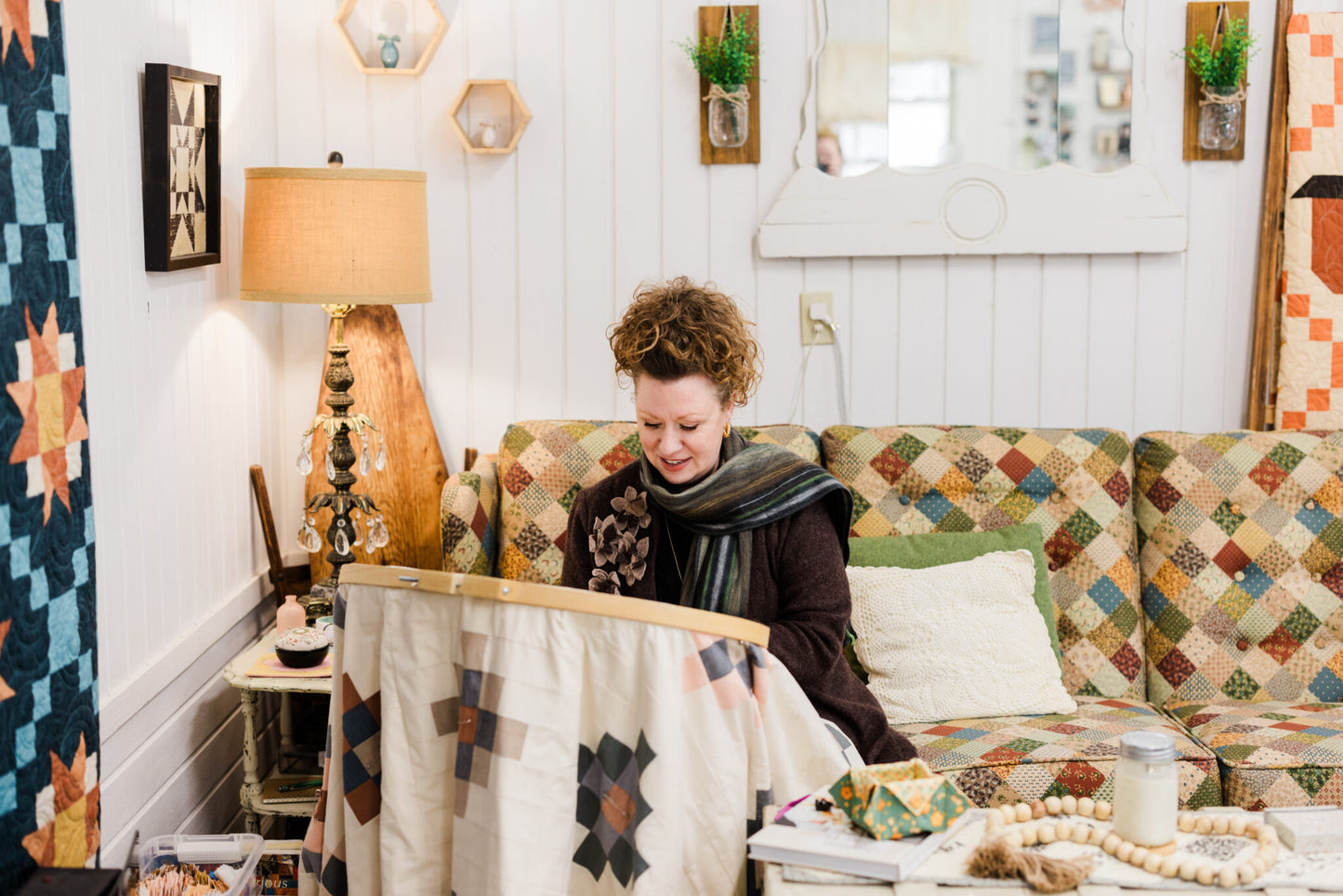 a woman quilting on a large quilt