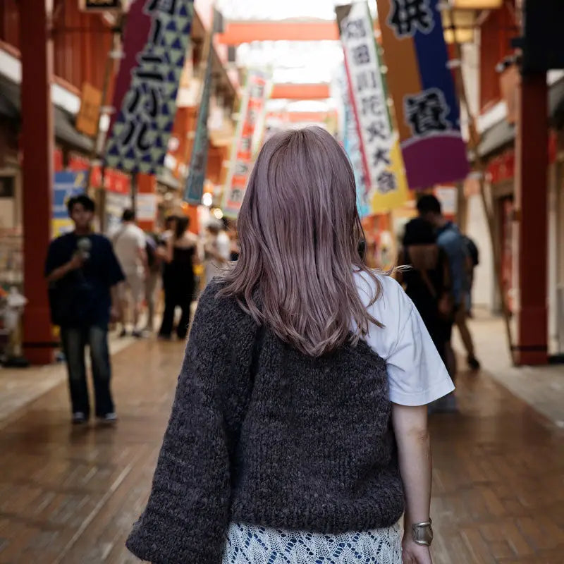 a gray one sleeved sweater