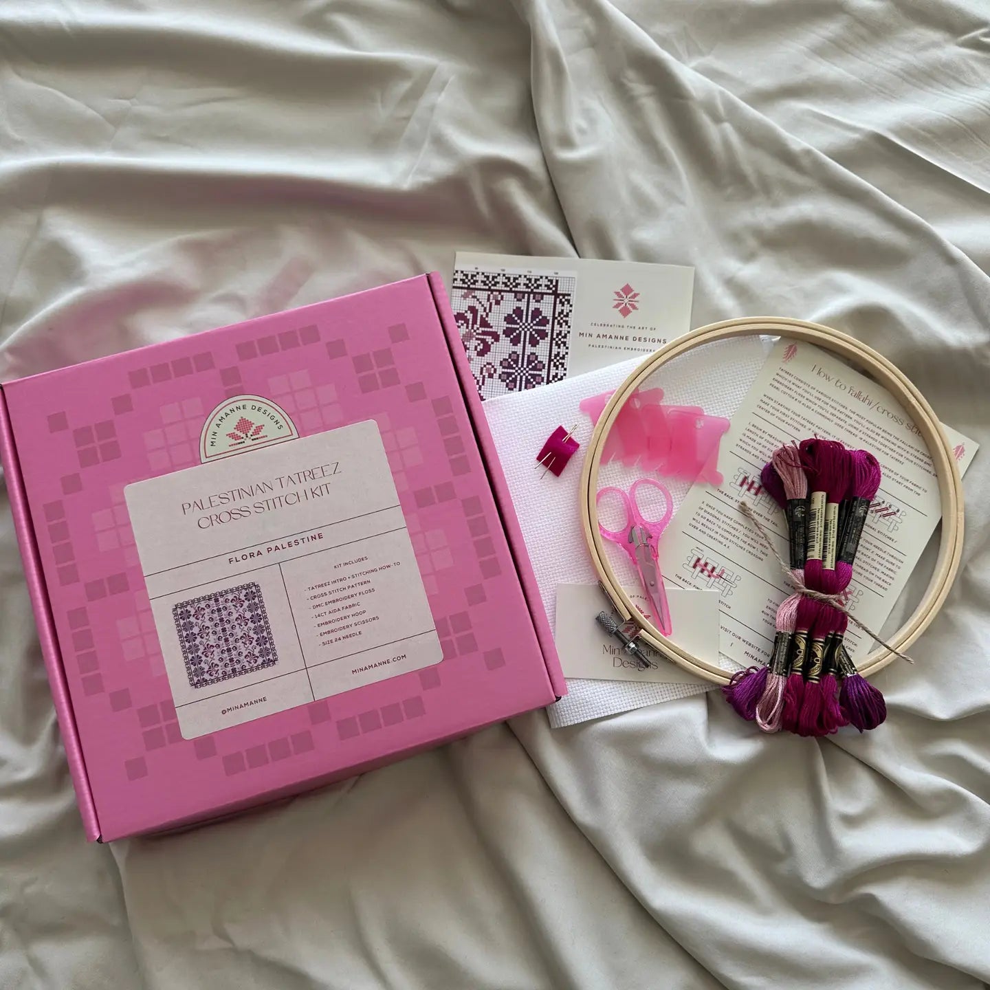 a pink box and cross stitch embroidery supplies