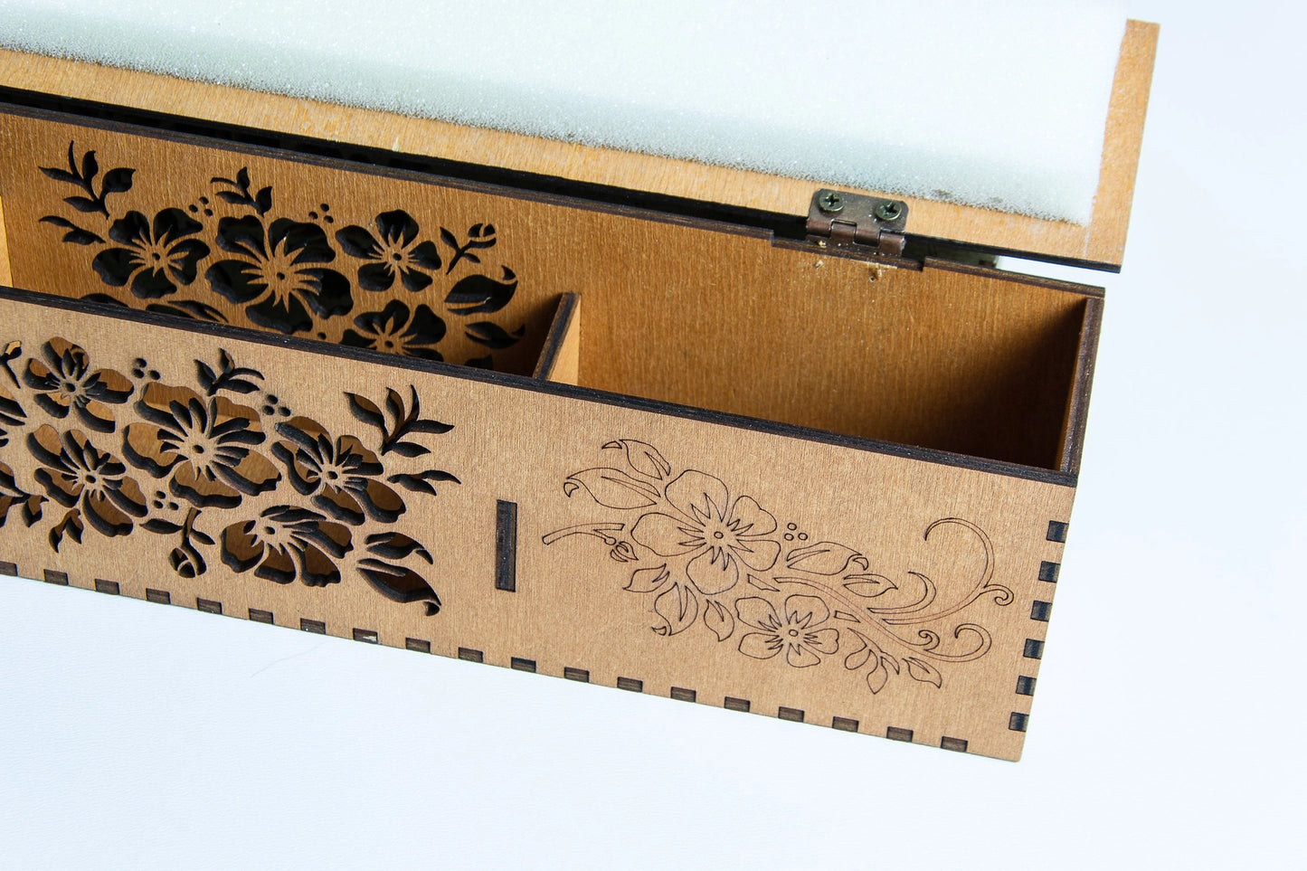 Wooden box with floral patterns on a light background