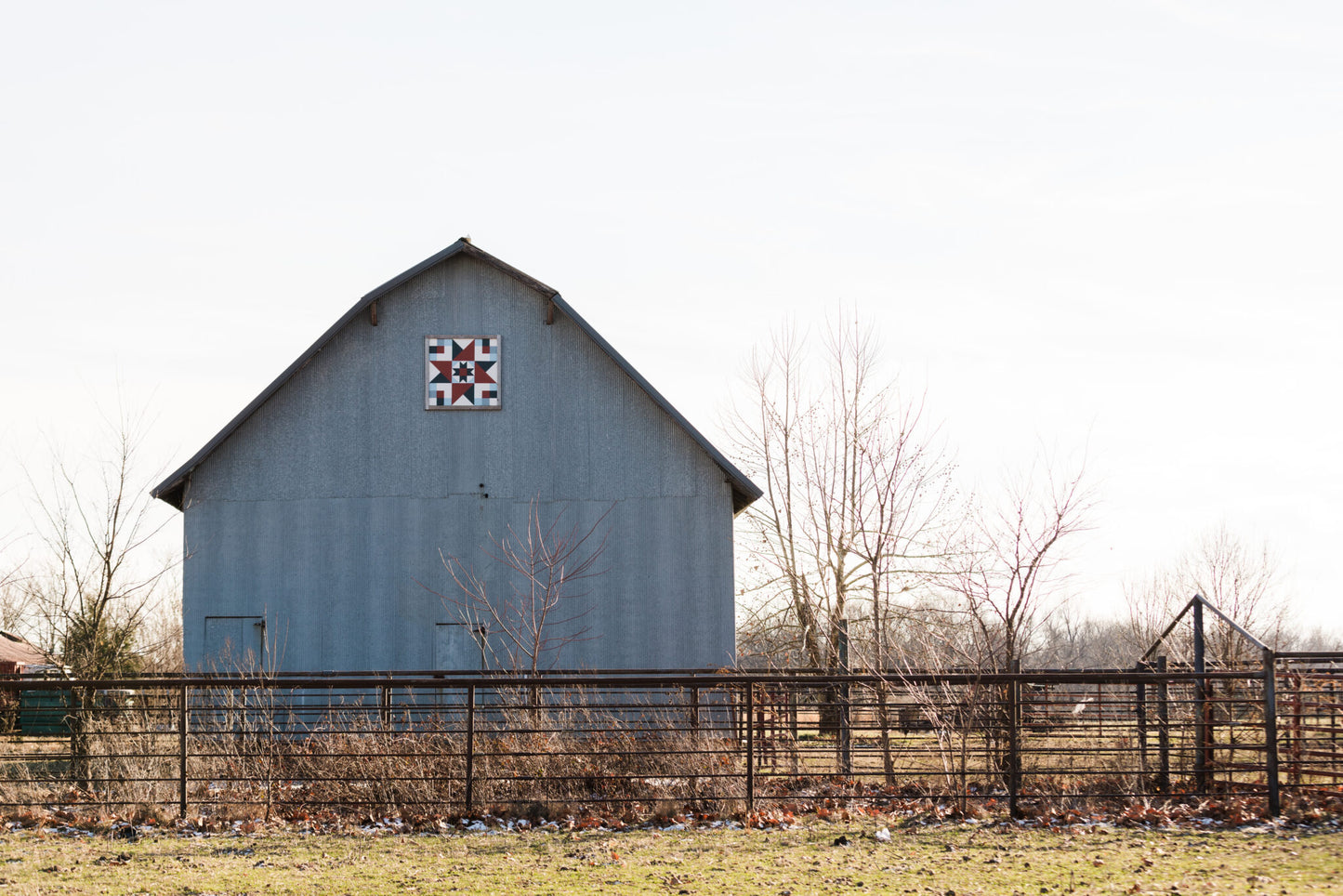 a gray barn with a painted quilt square