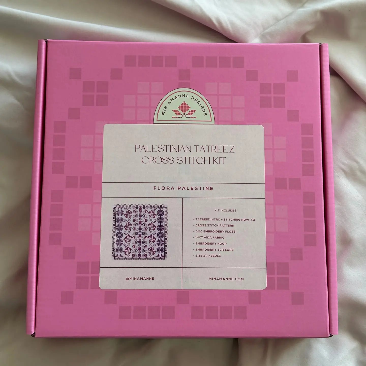 a pink box with a cross stitch embroidery kit