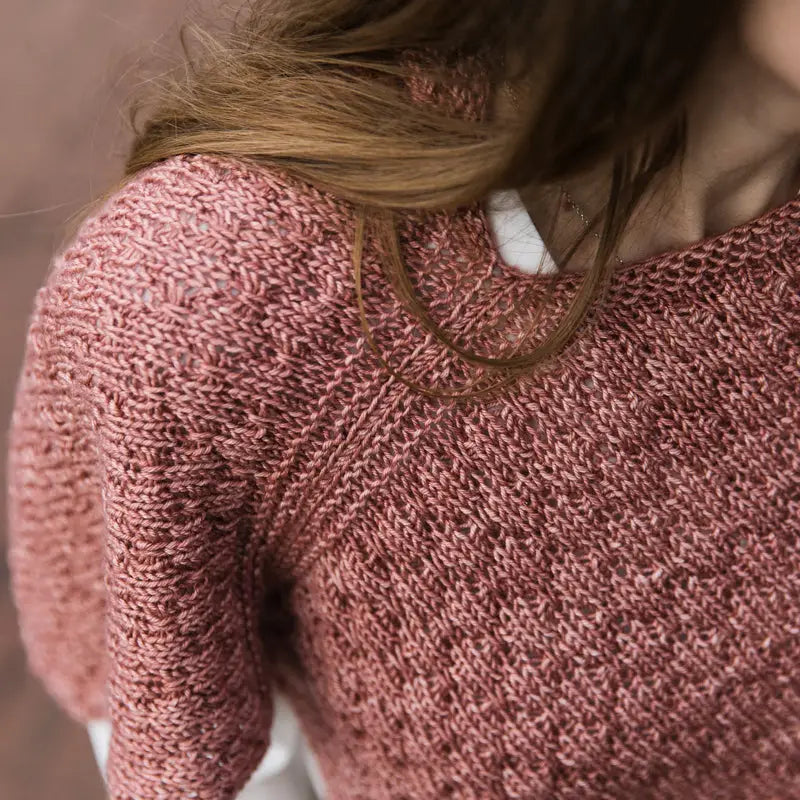 a textured pink sweater