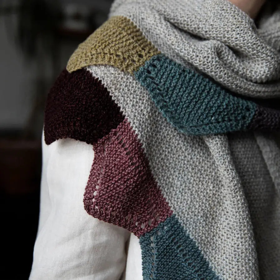 a gray scarf with colorful triangular edges