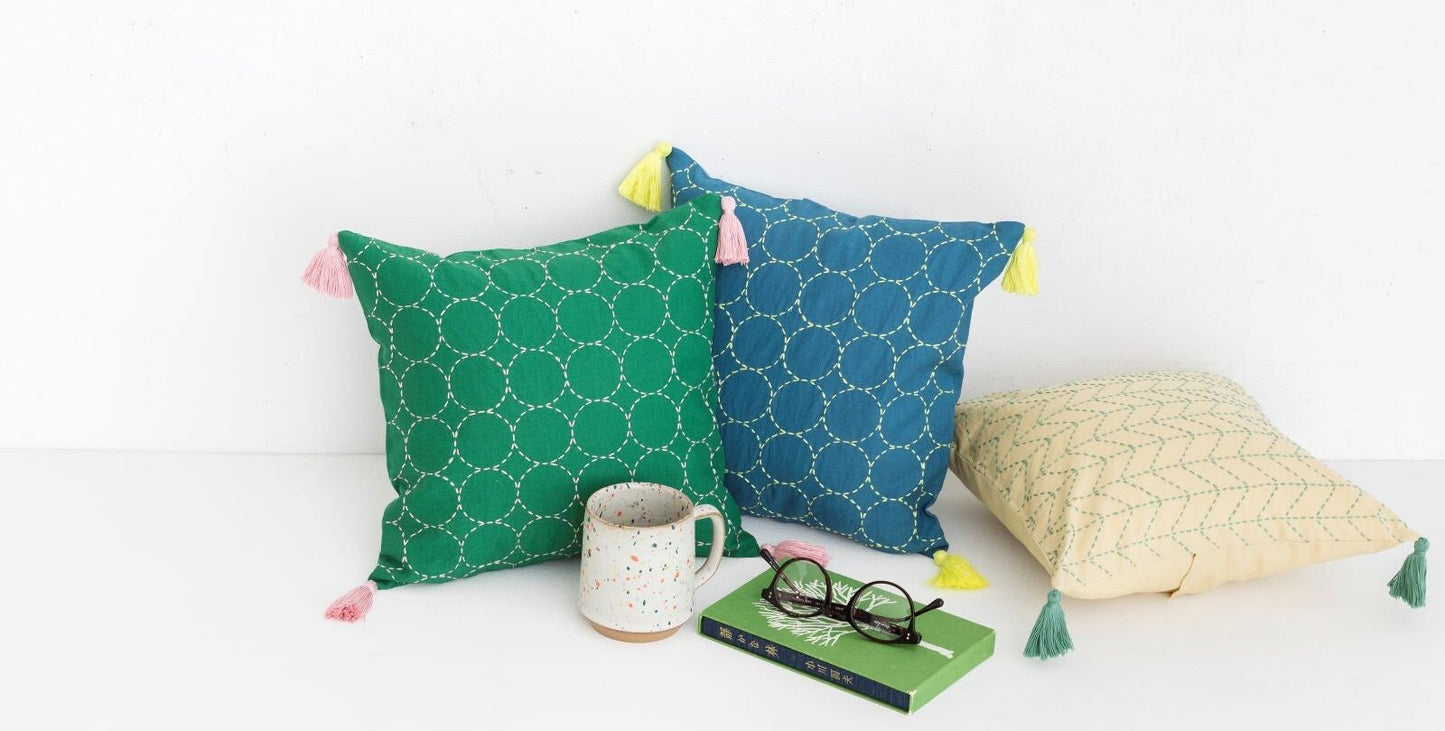 a green blue and ivory set of pillows stitched in a sashiko style
