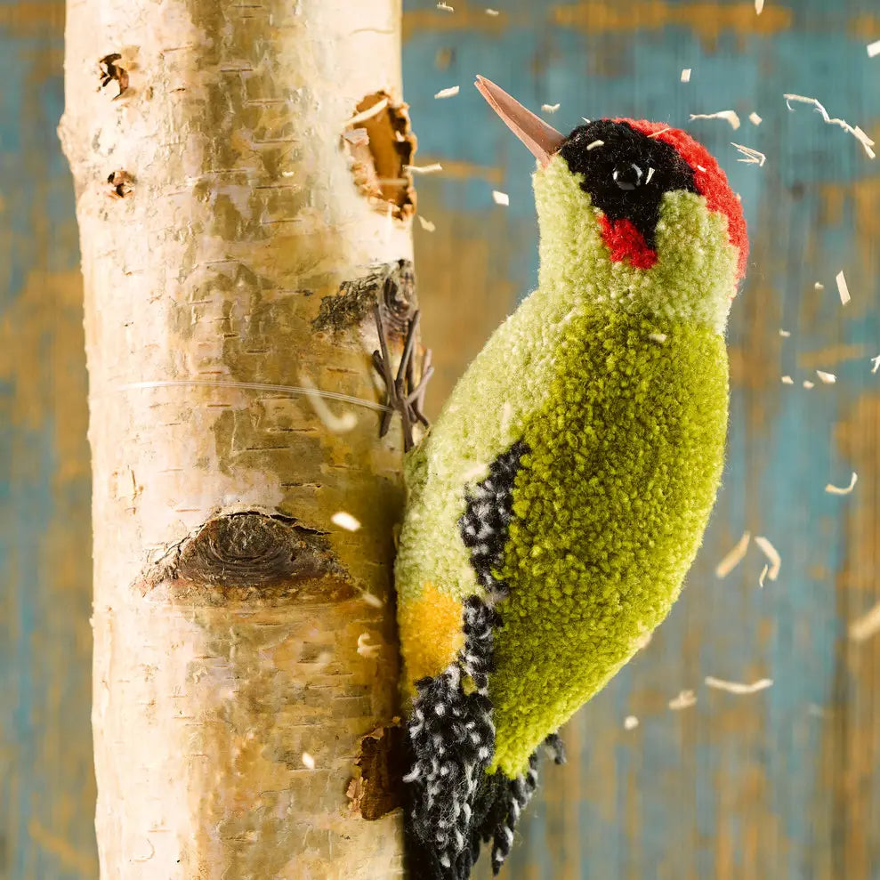 a green red and black woodpecker made with pom poms