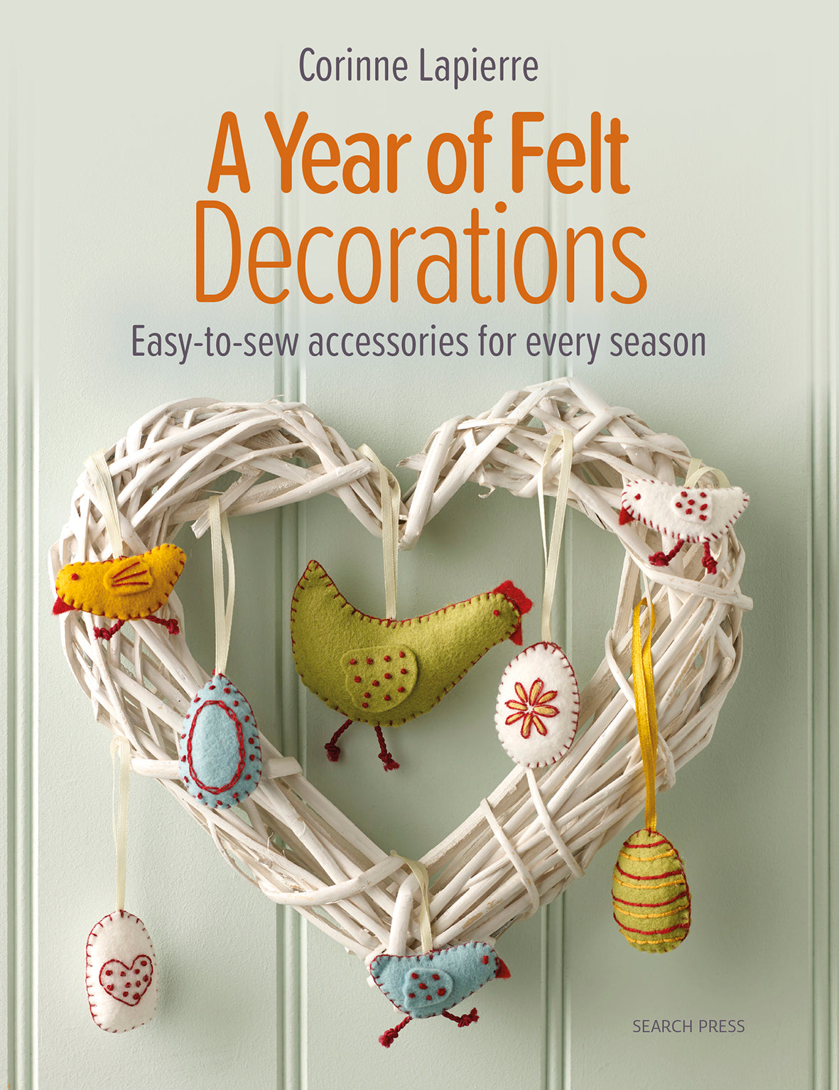 a white wreath decorated with felt hens and eggs