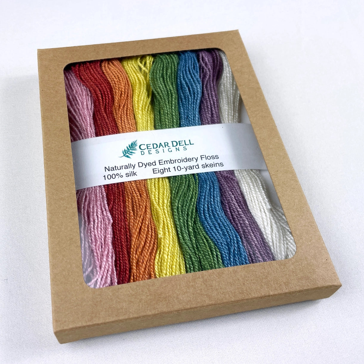 a brown box of rainbow dyed silk floss