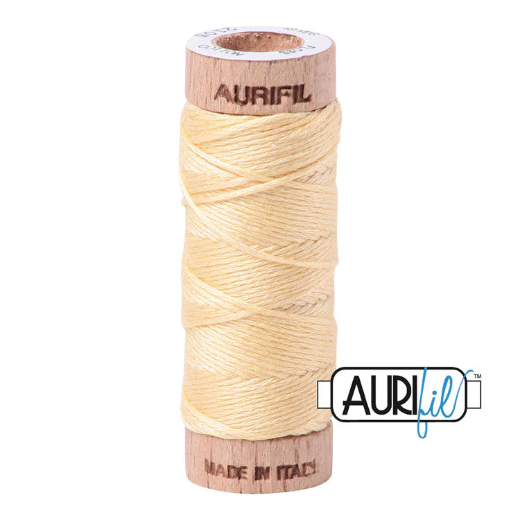 A spool of Aurifil 6-strand embroidery floss in yellow, wound around a wooden spool with the brand name visible.