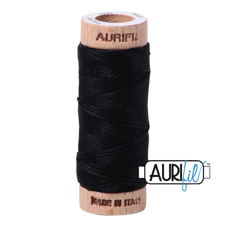 A spool of Aurifil 6-strand black embroidery floss wound around a wooden spool.