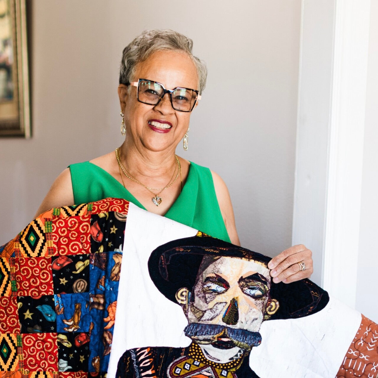 Beverly Huggins Kirk with a colorful quilt