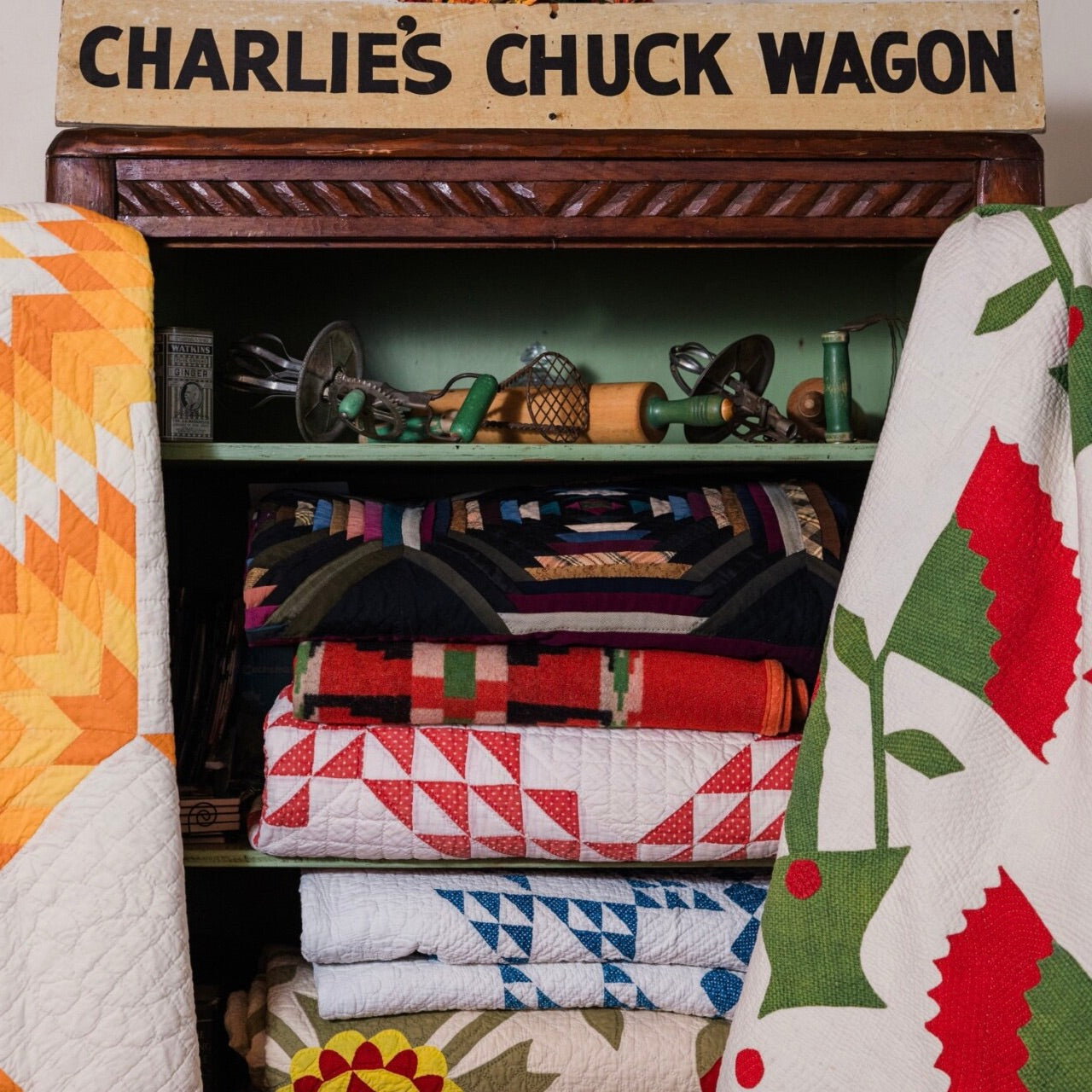 Cindy Rennels quilt collection in a cabinet