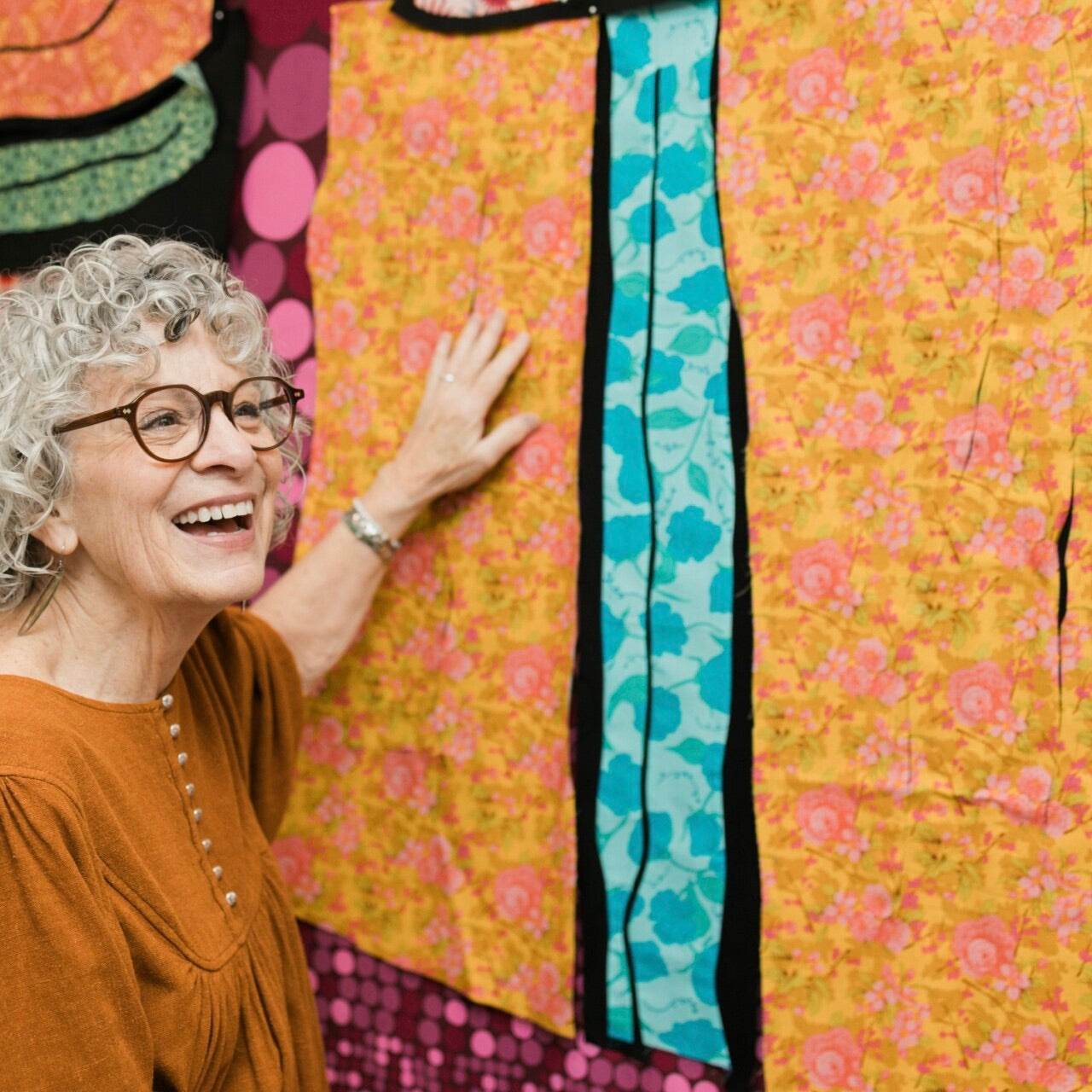 Patti Coppock Bucklin with a colorful quilt