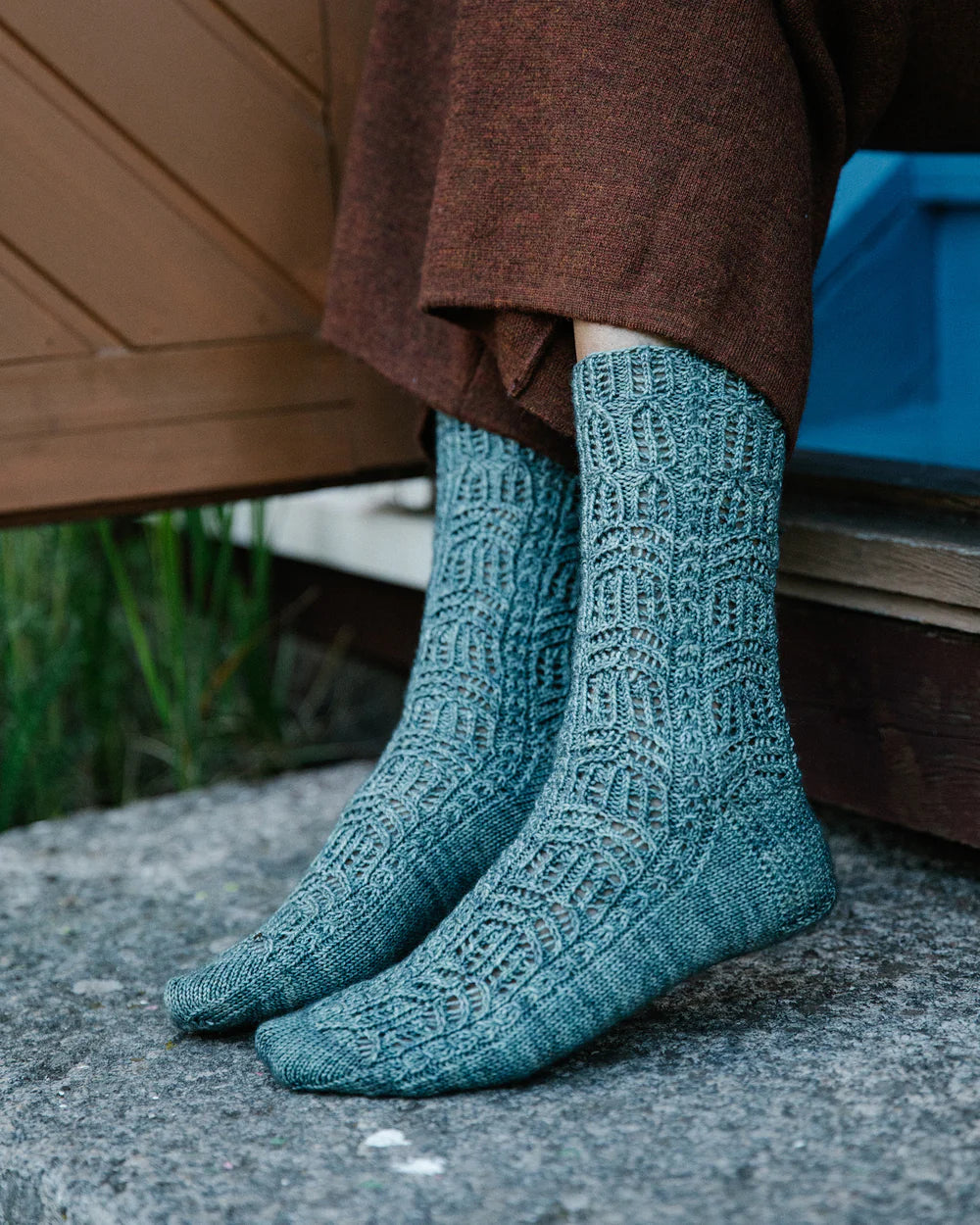 a light blue pair of socks with lace detail