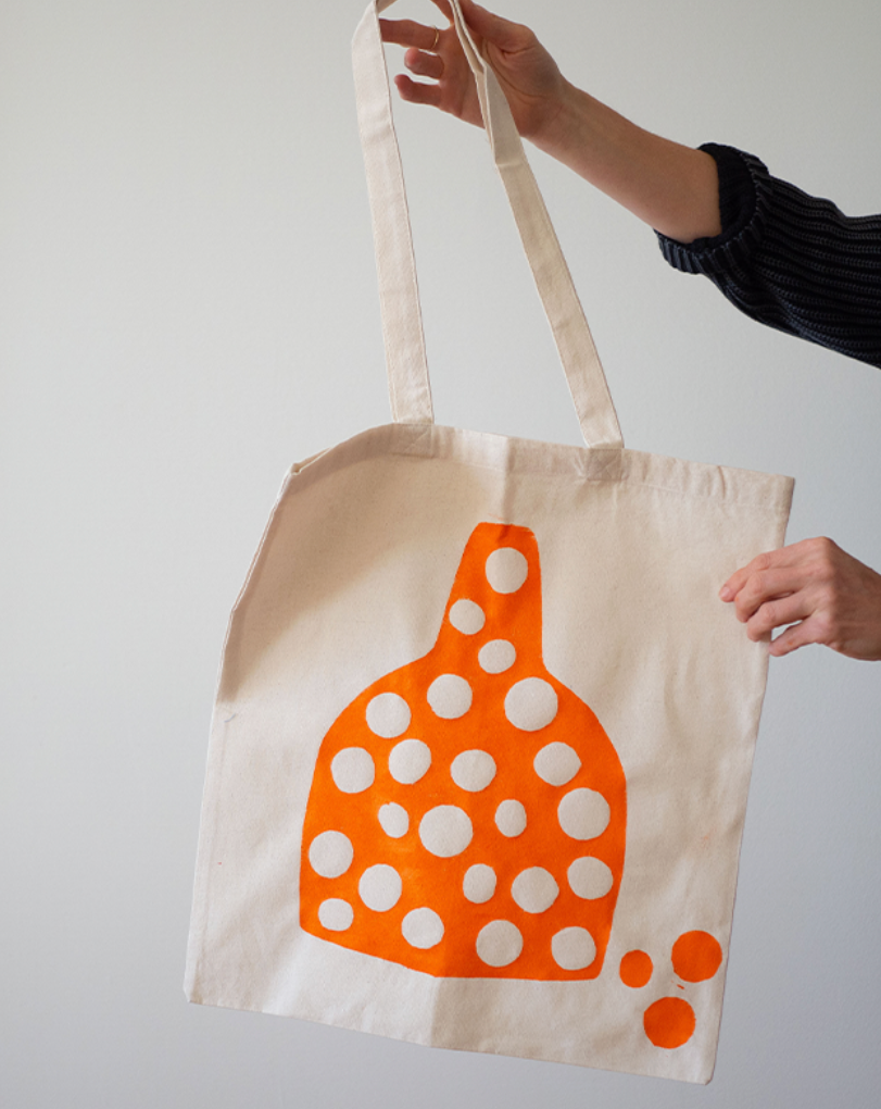 orange circle print on a canvas tote bag