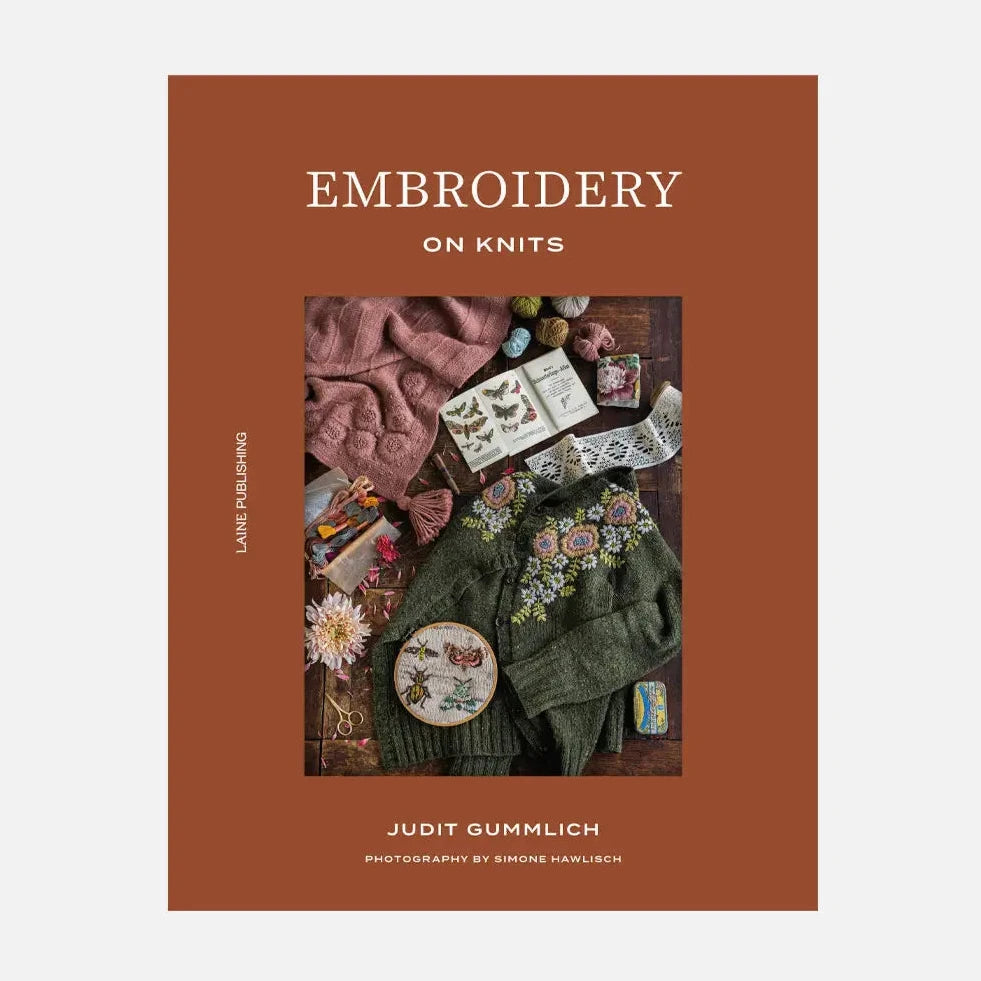 a brown book cover with embroidered knits