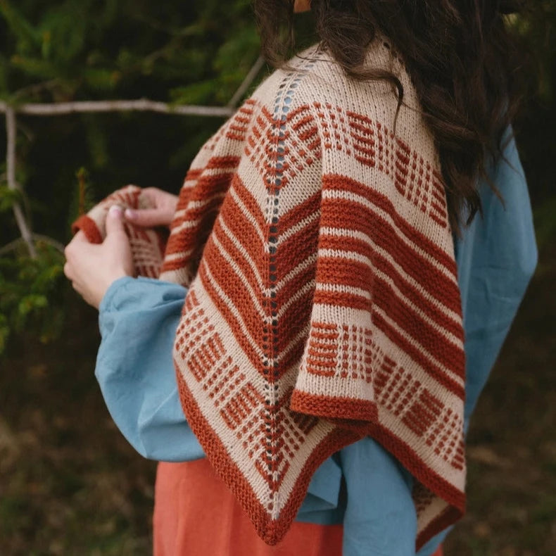 Person wearing a patterned shawl outdoors