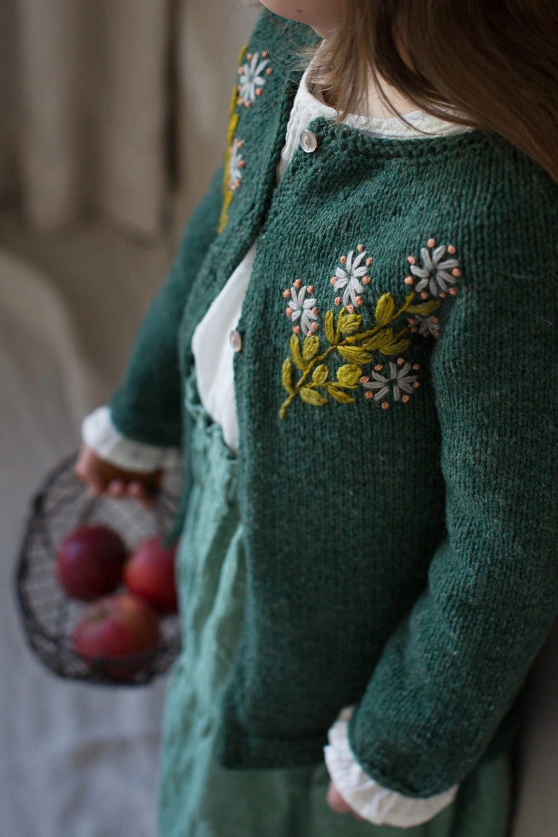 a green cardigan embroidered with flowers