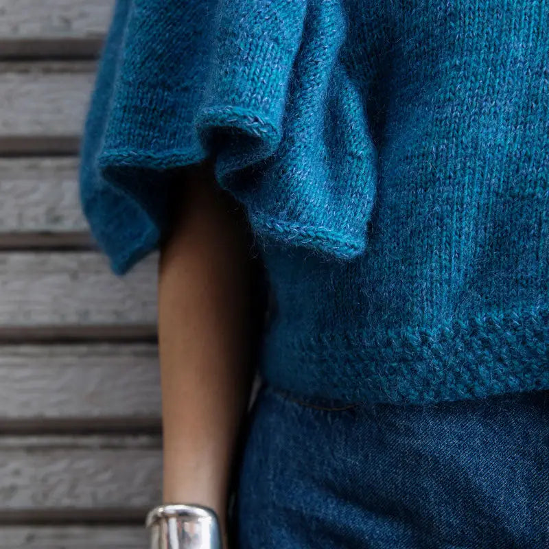 a blue knitted top with full sleeves