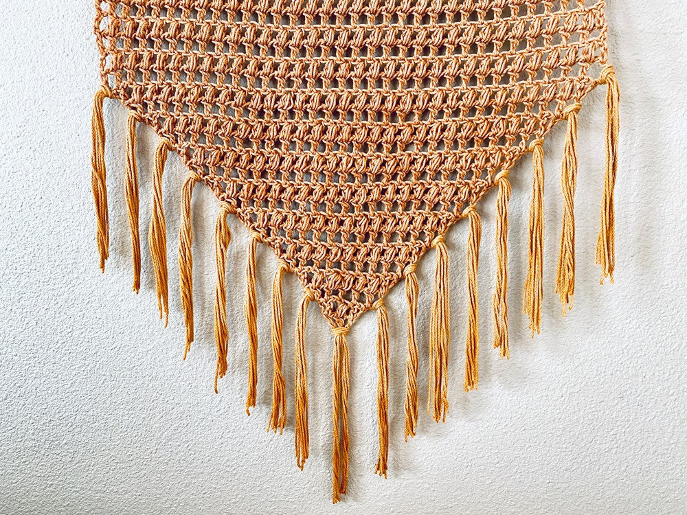 a brown crochet wall hanging