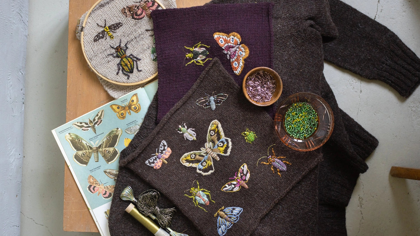 a brown sweater embroidered with colorful moths