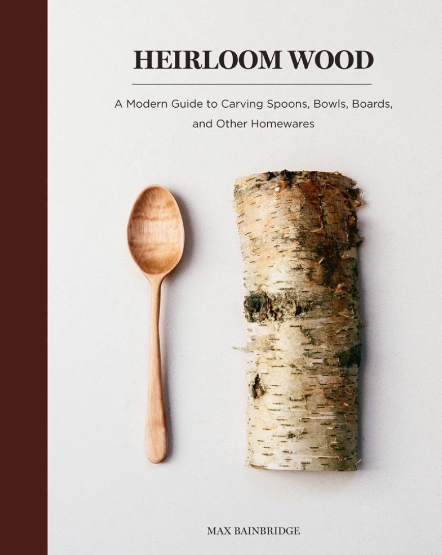 A hand carved spoon and a piece of wood
