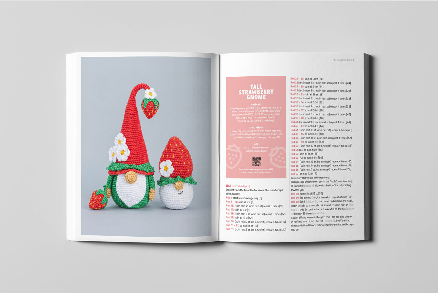 Open book showing crochet strawberry gnome patterns on a gray background