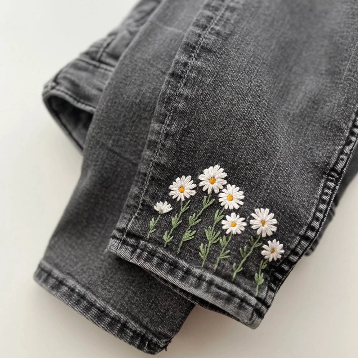 daisy embroidery on dark jeans