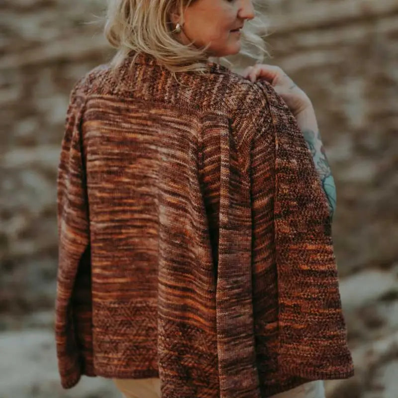 a woman wearing a brown variegated cardigan