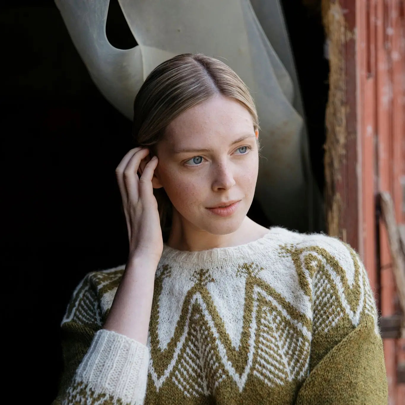 a woman wearing and green and white sweater