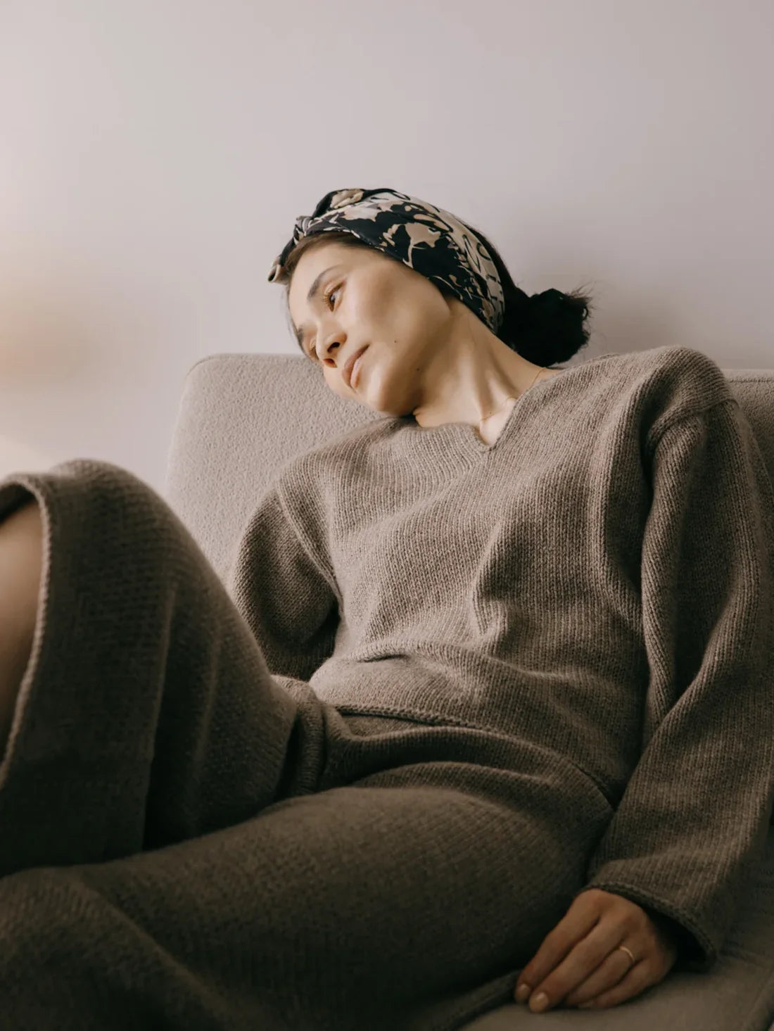 a woman wearing a brown hand knit sweater