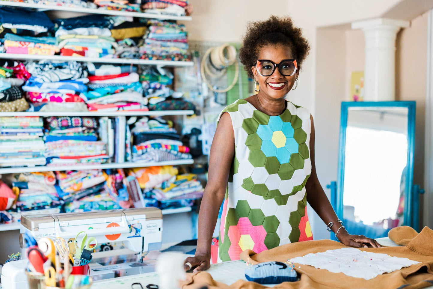 Woman in a colorful dress standing in a fabric store