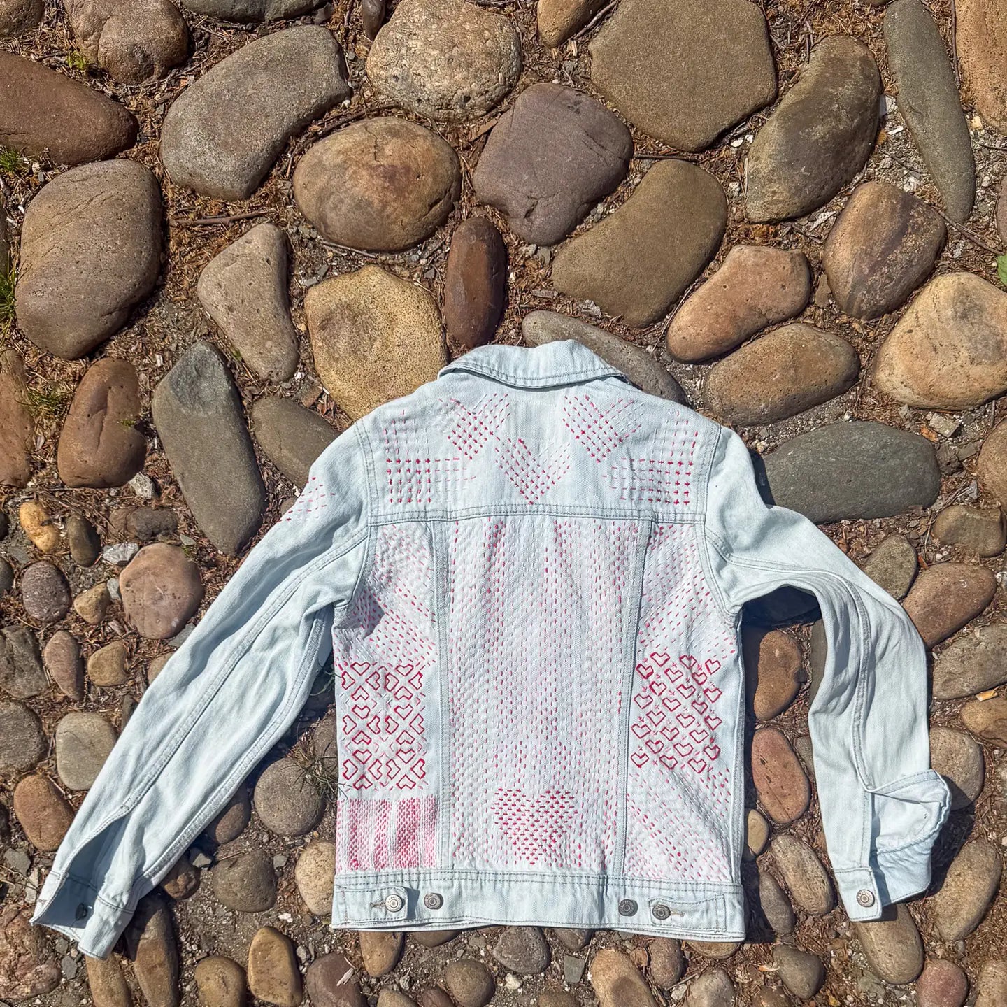 Denim jacket with embroidered patterns on a pebble ground