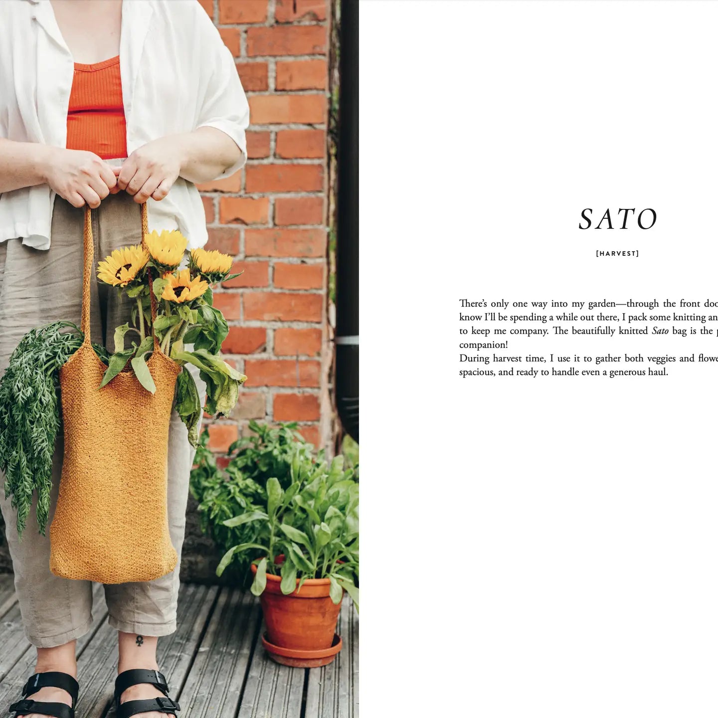 Person holding a woven bag with flowers and plants, standing in front of a brick wall.