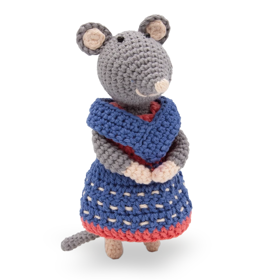 Crocheted mouse toy wearing a blue dress with a red border on a white background