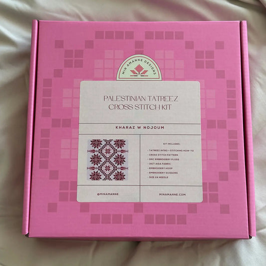a pink box with a cross stitch embroidery kit