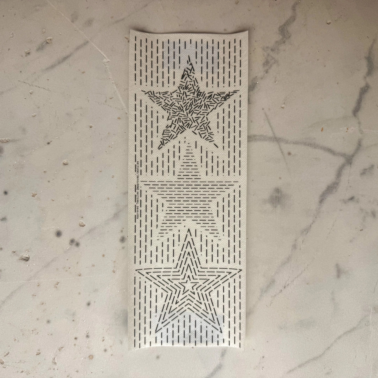 Decorative panel with star patterns on a textured wall