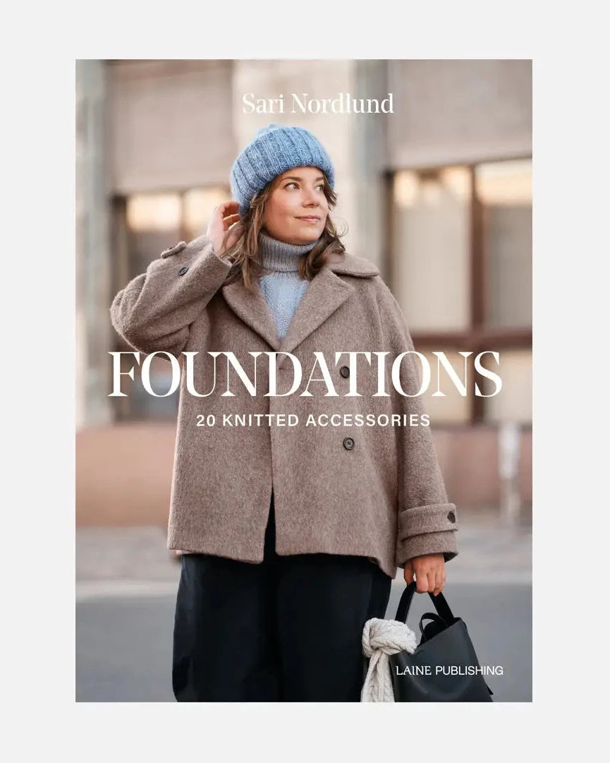 Book cover of 'Foundations' by Sari Nordlund featuring a person wearing a coat and blue beanie.