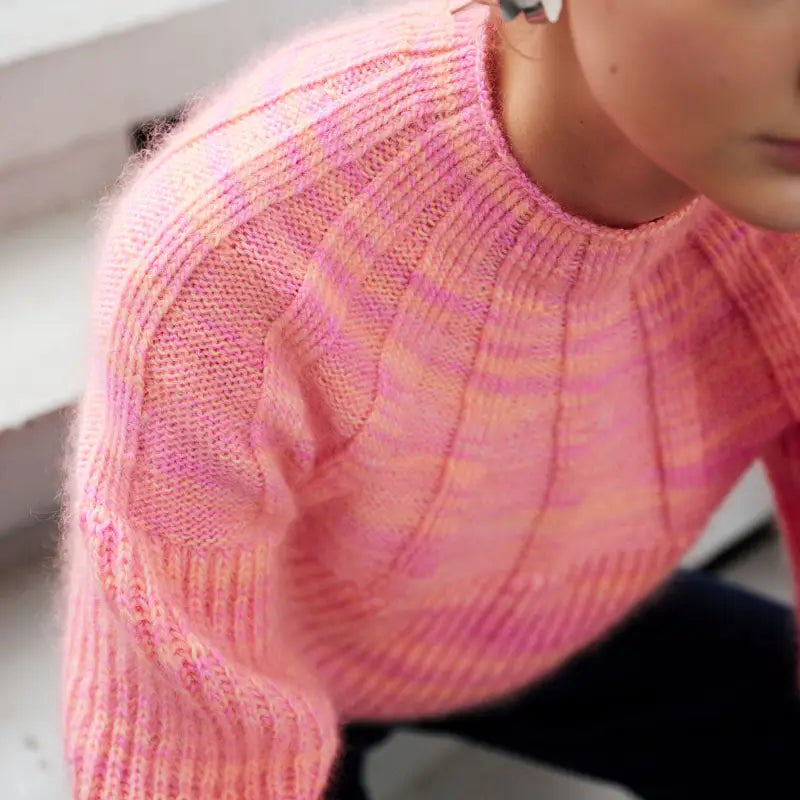 a bright pink and orange textured ribbed sweater