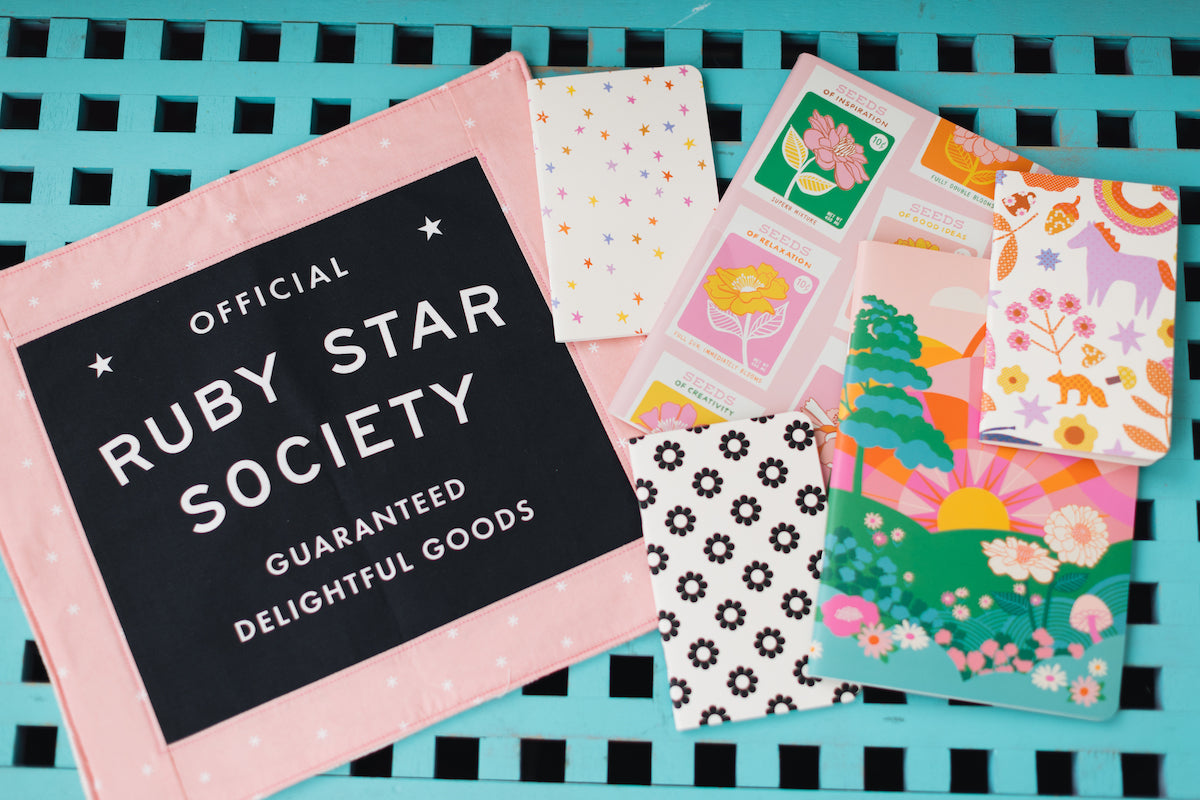 Collection of patterned cards with 'Official Ruby Star Society' branding on a teal and black checkered background.
