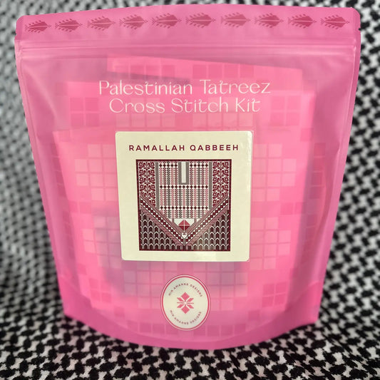 a pink pouch with a cross stitch kit