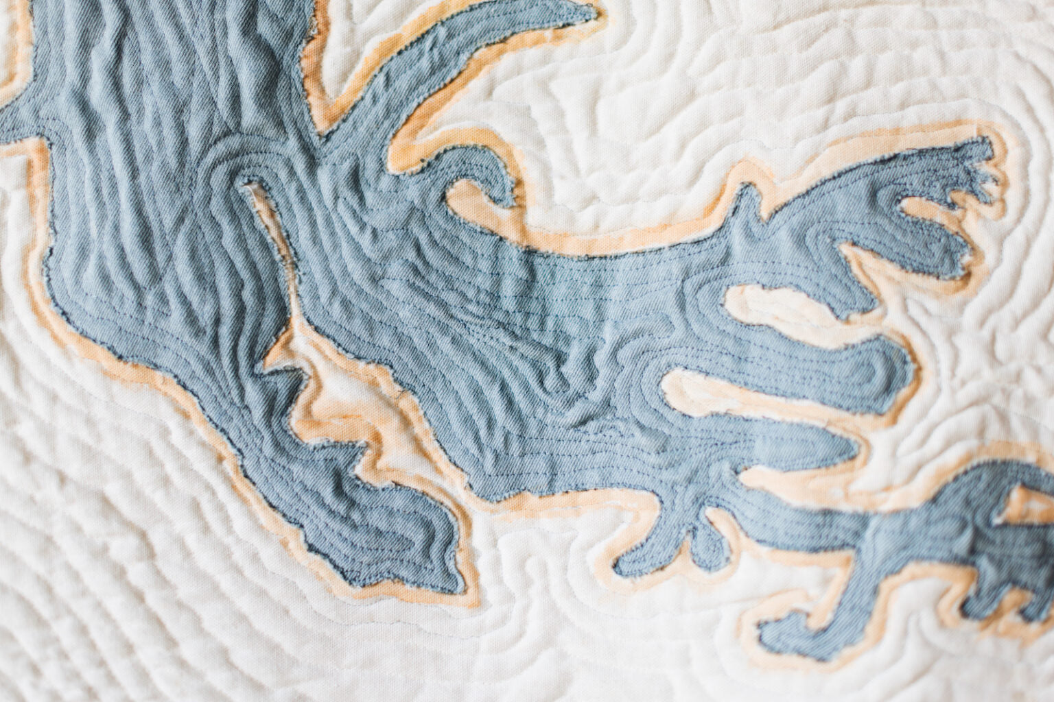 Close-up of a textured fabric with a map design in blue and beige.