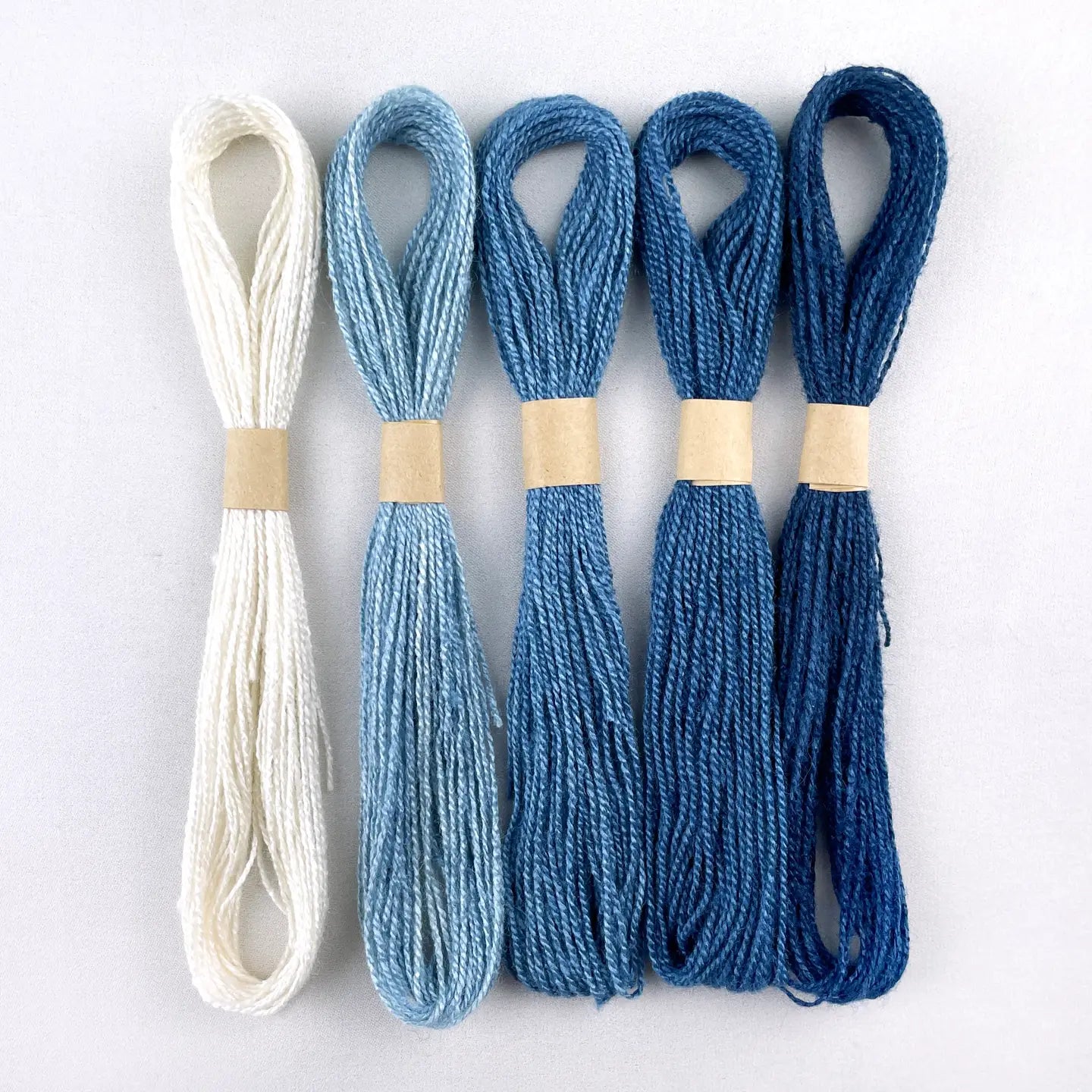 a set of blue ombre indigo dyed threads