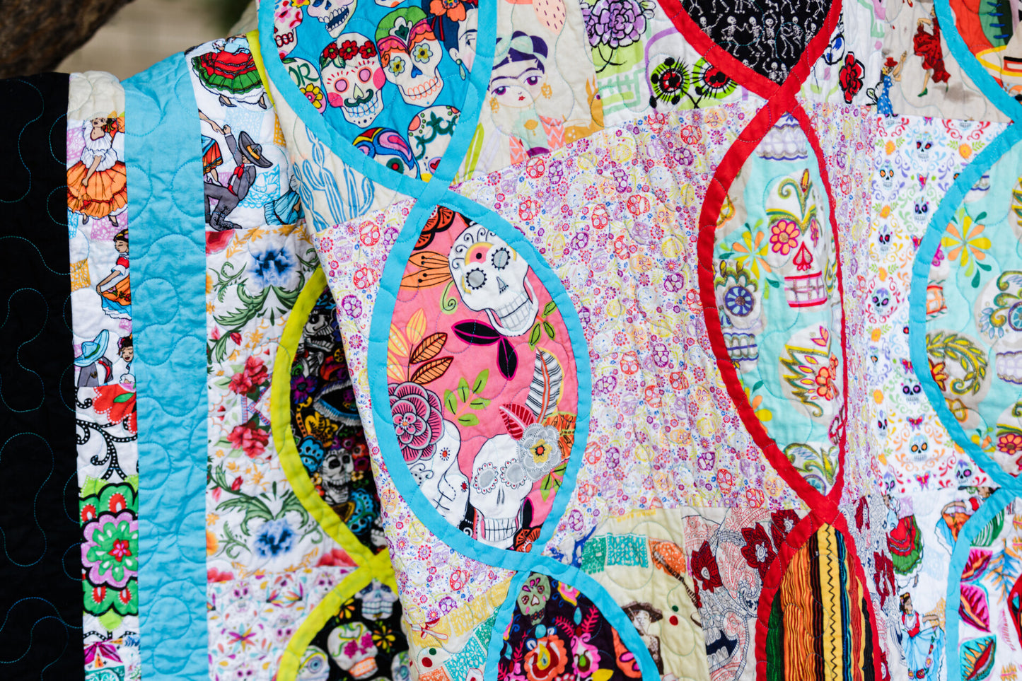 a colorful oval pieced quilt