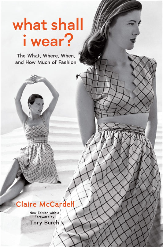 Book cover of 'What Shall I Wear?' with a woman in a checkered dress on a beach.
