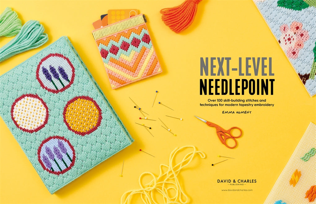 Book titled 'Next-Level Needlepoint' with needlepoint projects and materials on a yellow background