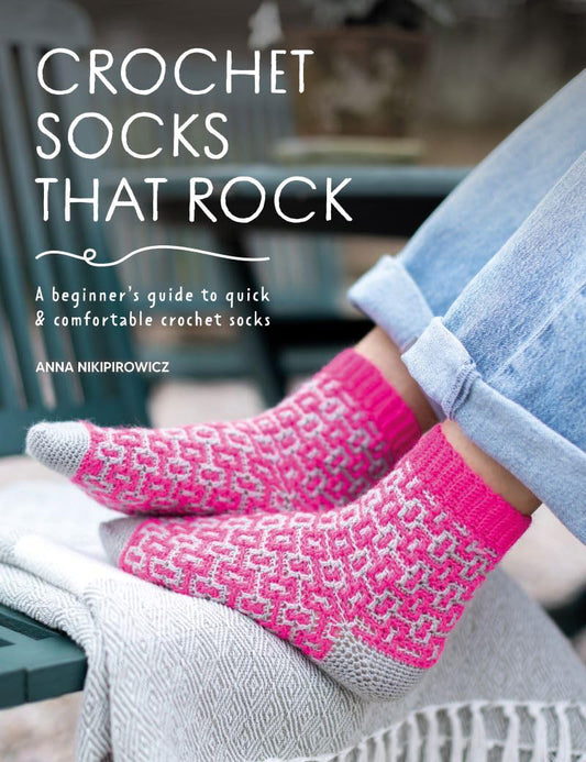 Book cover of 'Crochet Socks That Rock' by Anna Nikpirowicz with pink crochet socks on a blurred background.